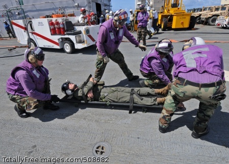 101016-N-3237D-066
CARIBBEAN SEA (Oct. 16, 2010) Aviation boatswain's mates simulate removing an injured pilot from a helicopter during a mass casualty drill on the flight deck of the multi-purpose amphibious assault ship USS Iwo Jima (LHD 7). Iwo Jima is in route to Guyana in support of the Continuing Promise 2010 humanitarian civic assistance mission. The assigned medical and engineering staff embarked aboard Iwo Jima will work with partner nation's teams to provide medical, dental, veterinary, and engineering assistance to eight different nations. (U.S. Navy photo by Mass Communication Specialist 3rd Class Morgan E. Dial/Released) 
