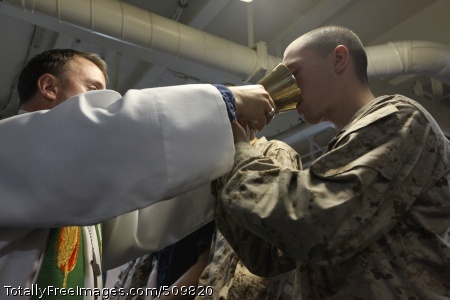 100912-M-2275H-218
MEDITERRANEAN SEA (Sept. 12, 2010) Lt. Cmdr. Daniel Berteau, command chaplain for the Kearsarge Amphibious Ready Group, offers communion to Lance Cpl. William James, a rifleman assigned to the 26th Marine Expeditionary Unit (26th MEU), during a Sunday church service aboard the amphibious assault ship USS Kearsarge (LHD 3). The Kearsarge ARG is supporting Pakistan flood relief efforts. (U.S. Marine Corps photo by Lance Cpl. Tammy Hineline/Released)