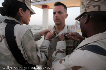 100916-N-0475R-137
CAMP LEATHERNECK, Afghanistan (Sept. 16, 2010) Chief Equipment Operator Thomas Colesanti, center, assigned to the Naval Mobile Construction Battalion (NMCB) 5, has his chief petty officer anchors pinned on his collar by Senior Chief Logistics Specialist Lisa Suchil, left, and Senior Chief Equipment Operator Joseph Hampton at a chief petty officer pinning ceremony at Camp Leatherneck, Afghanistan. The Seabees of NMCB-5 are deployed to Afghanistan executing general engineering, infrastructure construction and project management supporting Operation Enduring Freedom. (U.S. Navy photo by Mass Communication Specialist 2nd Class Ace Rheaume/Released) 