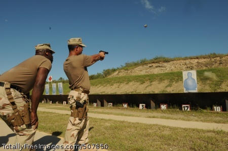 101028-N-4936C-240
GUANTANAMO BAY, Cuba (Oct. 28, 2010) Aviation Warfare Systems Operator Chief Eddie Gomez fires a 9 mm pistol as firing line coach Master-at-Arms 1st Class Errol Cummings looks on. Gomez and Cummings are both assigned to Navy Expeditionary Guard Battalion (NEGB). NEGB provides a portion of the guard force inside the Joint Task Force Guantanamo detention facilities. (U.S. Navy photo by Mass Communication Specialist 1st Class David P. Coleman/Released)