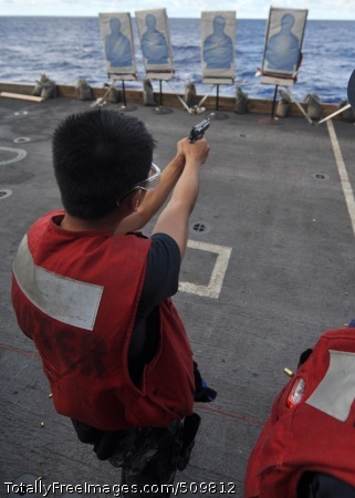 100914-N-2013O-038
PACIFIC OCEAN (Sept. 14, 2010) Interior Communications Electrician 3rd Class Kyle Adona, from Vallejo, Calif., fires an M-9 pistol during a small-arms live-fire exercise aboard the aircraft carrier USS George Washington (CVN 73). George Washington, the Navy's only permanently forward-deployed aircraft carrier, is underway helping to ensure security and stability in the Western Pacific Ocean. (U.S. Navy photo by Mass Communication Specialist 3rd Class Charles Oki/Released) 