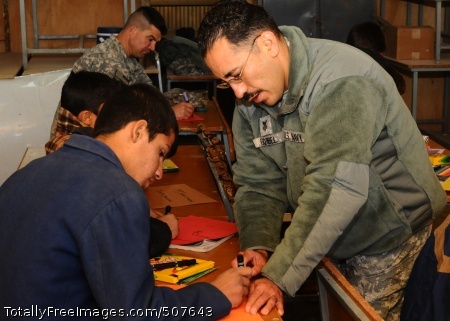 101107-F-7148M-001
CAMP SHAHEEN, Afghanistan (Nov. 7, 2010) Hospital Corpsman 1st Class Anthony Esquibel, a mentor to the Afghan National Army (ANA) 209th Corps, practices conversational English with the children of ANA soldiers. Esquibel became a volunteer of the Camp Mike Spann English Conversation Club to augment existing English classes and help students practice their pronunciation skills. Permanently stationed at the Expeditionary Combat Readiness Center in Norfolk, Va., Esquibel is serving a seven-month deployment with the Medical Embedded Training Team of NATO Training Mission-Afghanistan to assist in the development and training of his Afghan counterparts at the 209th Corps Regional Hospital. (U.S. Air Force photo by Tech. Sgt. Casey Martin/Released) 