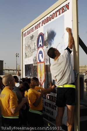 100911-N-9958G-005
CAMP ARIFJAN, Kuwait (Sept. 11, 2010) Cmdr. Kenneth Whitwell, right, director of Branch Clinics at Expeditionary Medical Facility Kuwait (EMF-K), from Wilmington, Del., puts his name on the banner promoting the 9.11 kilometer commemorative run at Camp Arifjan in Kuwait, as Yeoman 2nd Class Viridiana Ramirez, center, from Pasadena, Calif., and Lt. Michael Messick, from Chesapeake, Va., look on. The 9.11-kilometer run served as a reminder of the terror attacks on New York, Washington, D.C., and Somerset, Pa., on Sept. 11, 2001. More than 500 Camp Arifjan personnel from all branches of service and civil service took part in the run. (U.S. Navy photo by Chief Mass Communication Specialist Bill Gowdy/Released)
