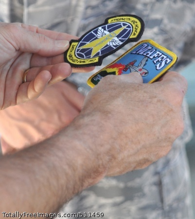 ETERSON AIR FORCE BASE, Colo. – Navy Adm. James A. Winnefeld, Jr., holds both the 34th Aeromedical Evacuation Squadron and the 302nd Airlift Wing’s Modular Airborne Firefighting System patches in his hand after being presented them from 302nd AW leadership July 26 at Peterson Air Force Base, Colo. Winnefeld, commander of the North American Aerospace Defense Command and U.S. Northern Command, together with senior leaders from both organizations, visited the Air Force Reserve’s 302nd AW to gain a better understanding of the specialized missions the AF Reserve supports, to include aeromedical evacuation and aerial firefighting. The visit also showcased the capabilities Air Force Reservists can provide to civilian-related missions if called upon.