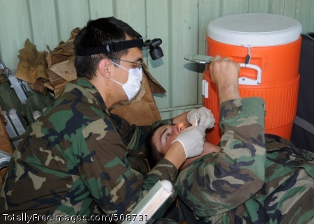 101014-N-9564W-151
CAMP SHELBY, Miss. (Oct. 14, 2010) Lt. David Stubbs, a Naval Mobile Construction Battalion (NMCB) 74 dental officer, performs an exam on Construction Mechanic Constructionman Nicholos Burbach inside a tricon container during a battalion field training exercise. (U.S. Navy photo by Mass Communication Specialist 1st Class Ryan G. Wilber/Released)