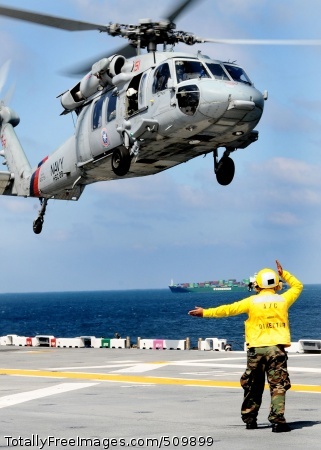 100913-N-7508R-042
ATLANTIC OCEAN (Sept. 13, 2010) An aircraft director aboard the multi-purpose amphibious assault ship USS Bataan (LHD 5) guides an SH-60S Sea Hawk helicopter assigned to the Dragon Whales of Helicopter Sea Combat Squadron (HSC) 28 onto the ship's flight deck. Bataan is underway conducting portions of a basic-training phase, including an aviation certification that will allow the ship to land and recover aircraft. (U.S. Navy photo by Mass Communication Specialist 2nd Class Julio Rivera/Released)
