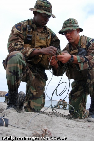 100912-N-7303M-082
SAN CLEMENTE ISLAND, Calif. (Sept. 12, 2010) Students in the third phase of Basic Underwater Demolition SEAL (BUD/S) training, double check each others work in building a standard charge on the beach of the BUD/S compound on San Clemente Island. A basic foundation in demolitions, weapons, and tactics training will aid them throughout their careers as Naval Special Warfare Operators. (U.S. Navy photo by Mass Communication Specialist 3rd Class Blake Midnight/Released)
