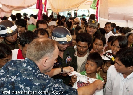101028-N-6770T-055
REAM, Cambodia (Oct. 28, 2010) Lt. Cmdr. Mike Morley, assigned to Commander Task Force 73 in Singapore, hands out donated clothes to local children at a medical civic action project during Cooperation Afloat Readiness and Training (CARAT) Cambodia 2010. CARAT is a series of bilateral exercises held annually in Southeast Asia to strengthen relationships and enhance force readiness. (U.S. Navy photo by Mass Communication Specialist 2nd Class Jason Tross/Released) 