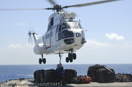 100925-N-8335D-545
PHILIPPINE SEA (Sept. 25, 2010) Damage Controlman Fireman Jasmine Bly and Seaman Arthur Hubbard hook a pole pendant to a Military Sealift Command SA-330j Puma helicopter aboard the amphibious dock landing ship USS Harpers Ferry (LSD 49) during a vertical replenishment with the Military Sealift Command dry cargo and ammunition ship USNS Alan Shepard (T-AKE 3). Harpers Ferry is part of the permanently forward-deployed Essex Amphibious Ready Group and is on patrol in the western Pacific Ocean. (U.S. Navy photo by Mass Communication Specialist 1st Class Richard Doolin/Released) 
